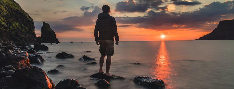 Someone Looking At The Sun On The Horizon